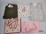 four pieces of clothing are laid out on a table