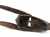 a small wooden object that is on a white surface