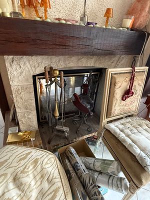 a fire place in the middle of a living room with a fireplace