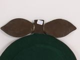 a green hat with two brown leaves on top of it