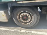 a truck that has a flat tire on the side of the road