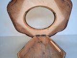 a wooden box with a mirror in it on a table