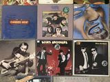 several albums of various music are laying on the floor