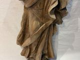 an old statue of a woman holding a bird in her hand