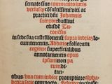 an old book with a red and black writing on it