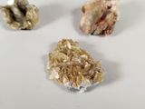 three different types of rocks on a white surface