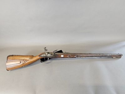 an old gun with a wooden handle on a white background