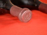 two bottles of wine sitting next to each other on a table