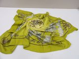 yellow scarf on a white table with a white table cloth
