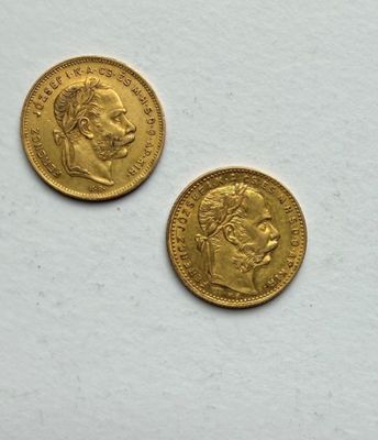 two pieces of gold coins on a white surface