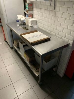 une cuisine équipée d'une table et d'un réfrigérateur