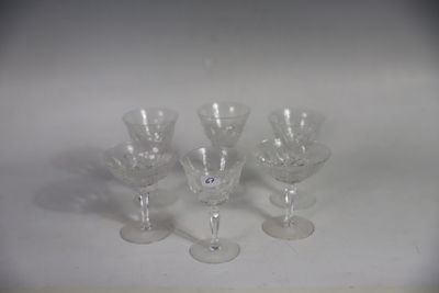 four wine glasses sitting on a table with a white background