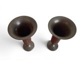 two brown vases sitting next to each other on a white surface
