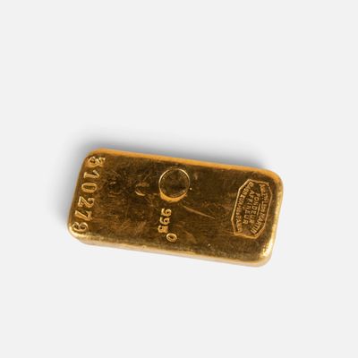 a close up of a gold bar on a white surface