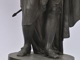 a statue of a man with a hat and a cane