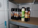 a shelf with spices and condiments on it