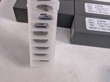 a person that is holding a piece of paper in front of a stack of boxes