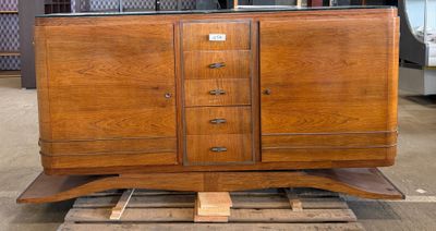 a wooden cabinet that is on a pallet in a warehouse