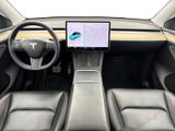 the interior of an electric car with a laptop on the dashboard