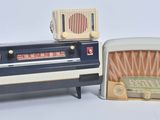 two old fashioned radio sets sitting next to each other