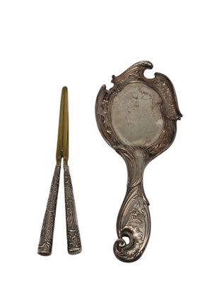 an image of a mirror and a pair of scissors on a white background