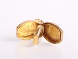 gold locke with open lid on white surface with white background