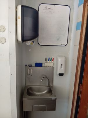 a sink and a tv in a small room