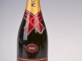 a close up of a bottle of champagne on a white surface