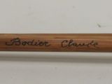 a close up of a wooden stick with writing on it