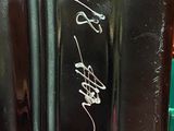a close up of a black vase with writing on it