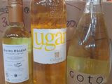 three bottles of wine sitting on a table next to a box