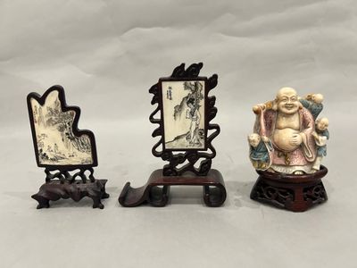 three chinese figurines of a man and a woman