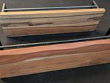 two wooden planters with metal handles on a carpeted floor