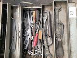 many tools in a metal box on the floor