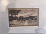la photo d'une photo représentant un paysage, exposée dans une vitrine