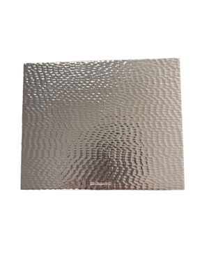 a close up of a piece of metal on a white background