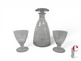 three wine glasses and a decanter on a white background
