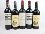 six bottles of wine are lined up in a row on a table