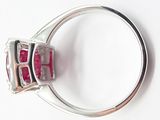 an image of a close up of a ring with a red stone