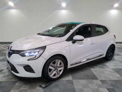 a white car parked in a garage with a checkered floor
