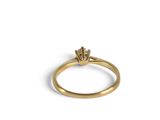 a close up of a gold ring with a diamond on top