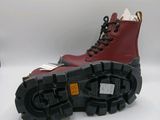 two pairs of red boots with black soles on a white surface
