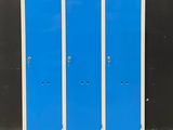 blue and white lockers against a black wall in a room