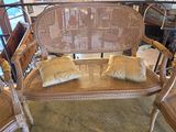 two wicker chairs and a bench in a room