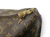 a close up of a louis vuitton bag with a key in it