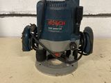 a close up of a bosch router on a table in front of a wall