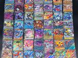 a pile of pokemon cards sitting on top of a table