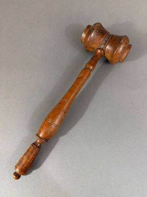 a wooden gaven with a wooden handle on a gray surface
