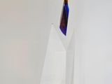 a glass vase with a blue and orange liquid inside of it