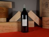 a bottle of wine sitting on a table next to wooden boxes